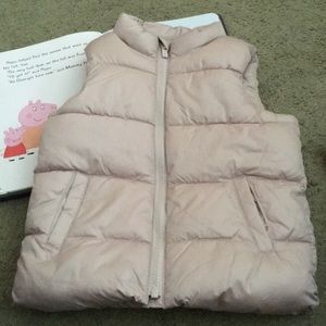 Shimmering beige with a pink hue puffer vest.
